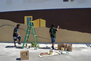 working on Mural wall on side of YB Building