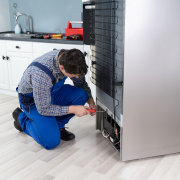 Male Worker Repairing Refrigerator