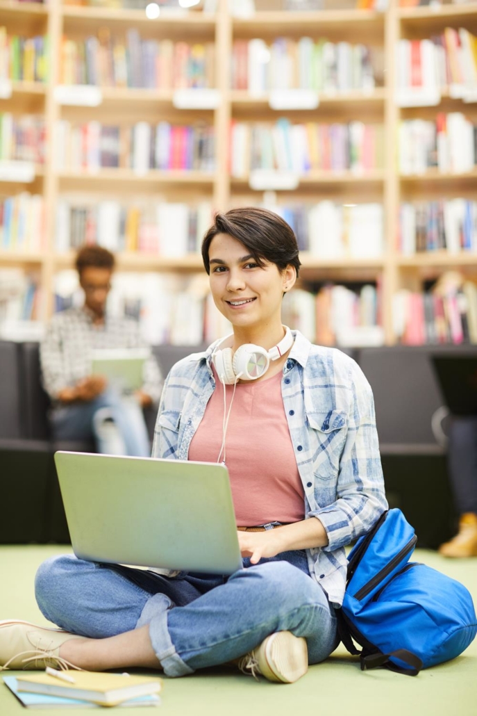 student girl using online resource on laptop utc