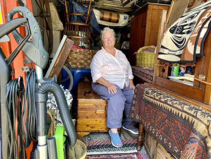 Judith sits in her storage container surrounded by her belongings.